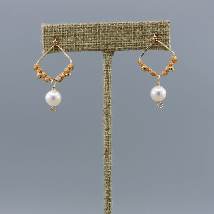 handmade square shaped gold macrame earrings with freshwater pearl beads on a linen hanger