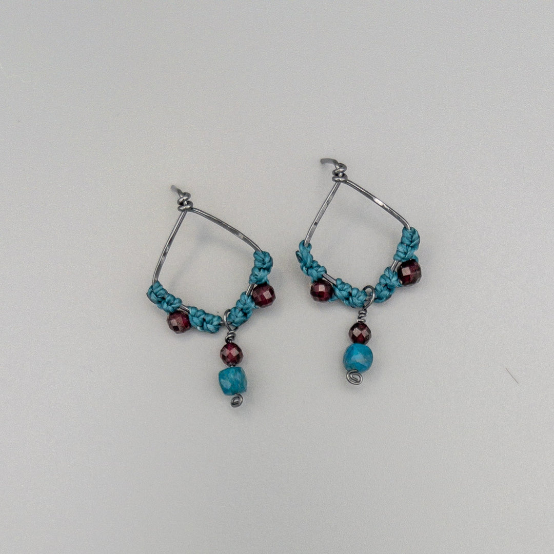 handmade oxidized sterling silver garnet macrame earrings on a gray background