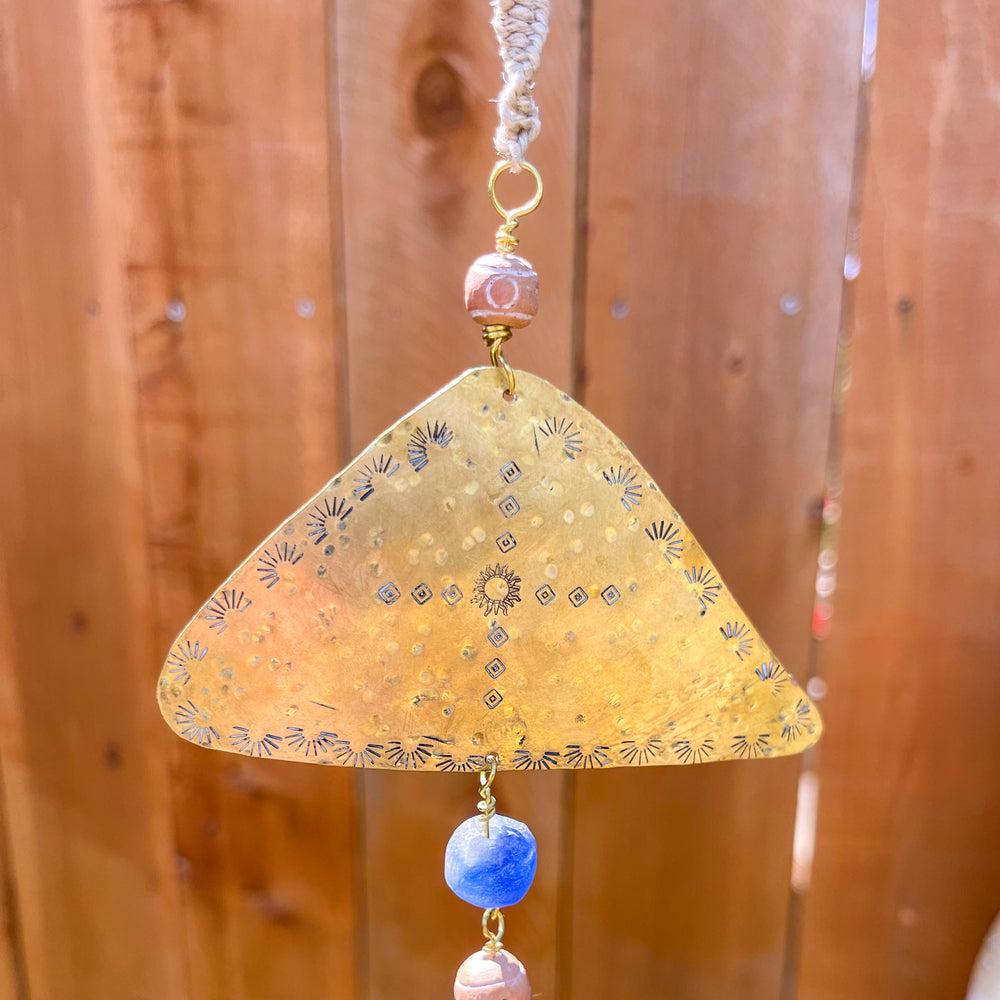 close up of handmade brass and crystal sun catcher with African glass beads