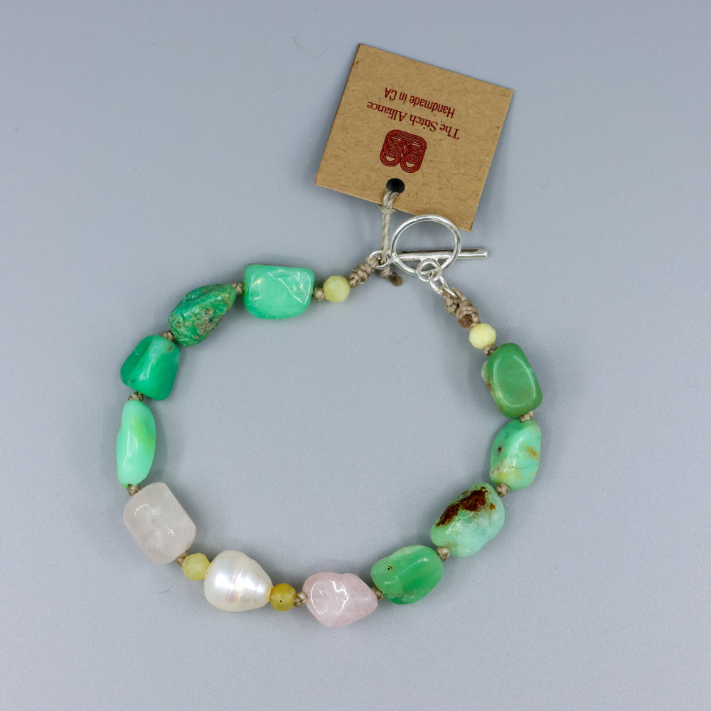 handknotted chrysoprase rose quartz and frehswater pearl bracelet with sterling silver clasp on gray background