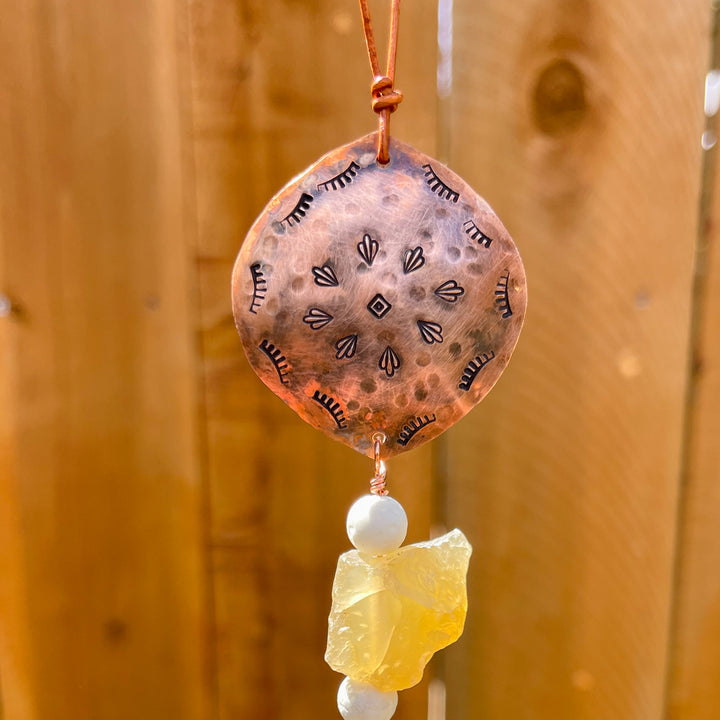 detail view of handmade copper and agate sun catcher