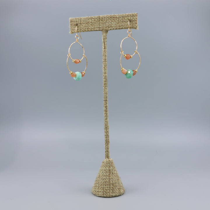 handmade gold fill double hoop earrings with amazonite and sunstone beads on a linen hanger