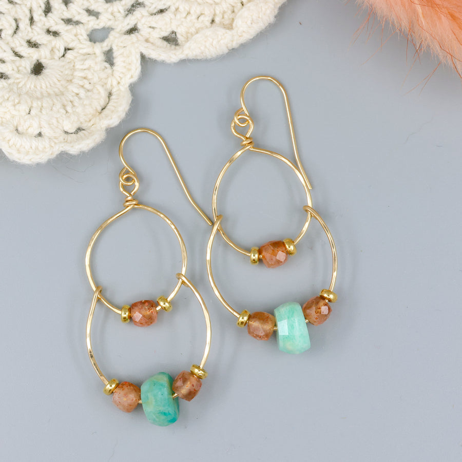 handmade gold fill double hoop earrings with amazonite and sunstone beads on a gray background