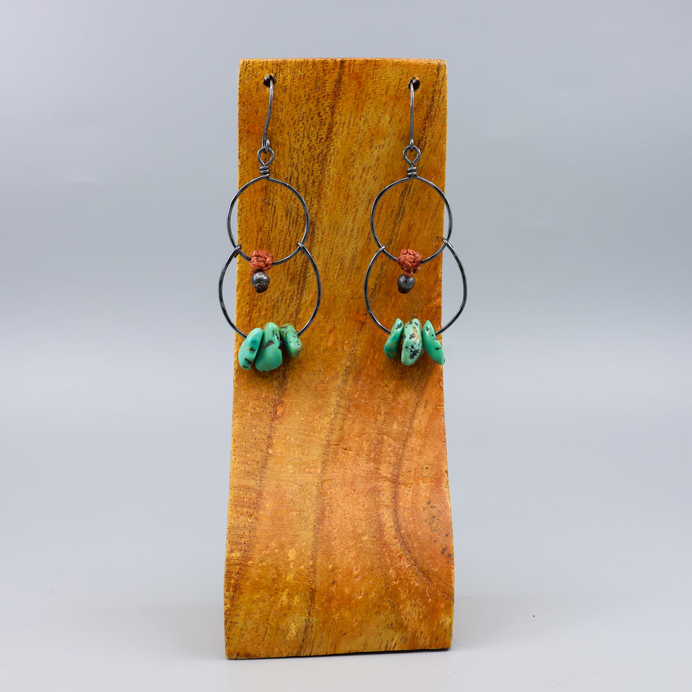 handmade double hoop earrings with turquoise beads and oxidized sterling silver on a wood display