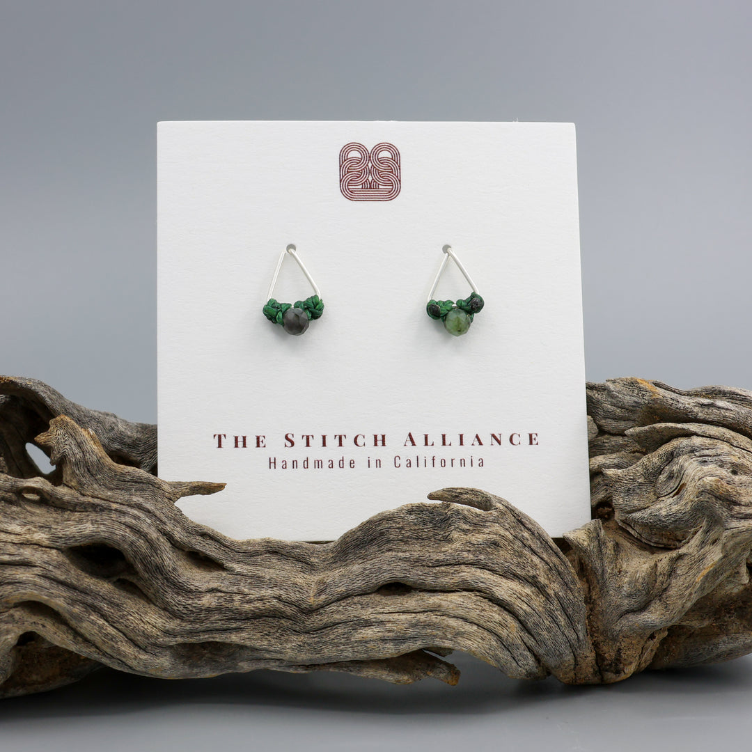 Emerald stud earrings sterling silver triangle on a white card