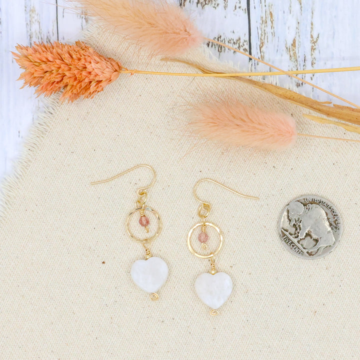 handmade gold filled dangle earrings with moonstone and strawberry quartz beads shown with coin for size comparison