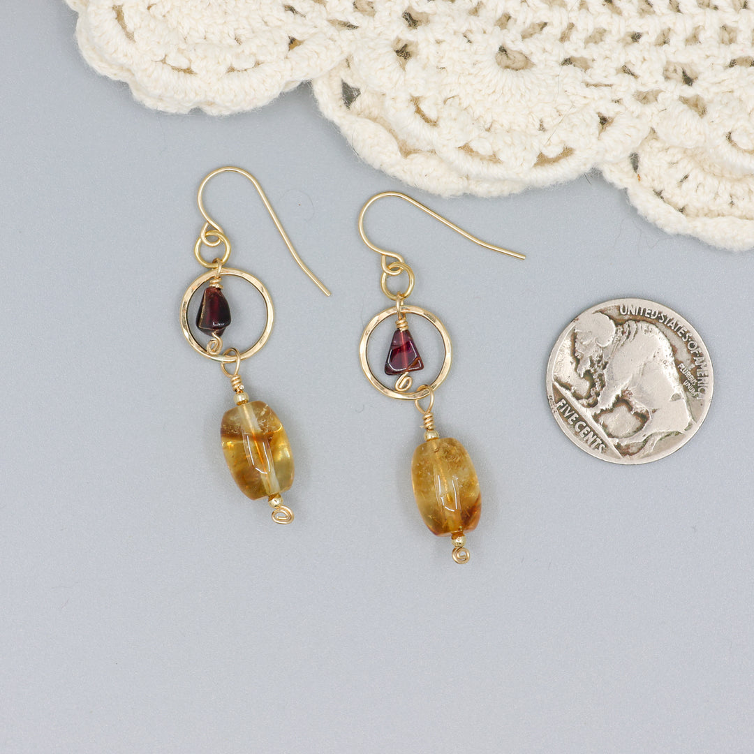 handmade citrine, garnet, and 14k gold filled earrings with a coin for size comparison