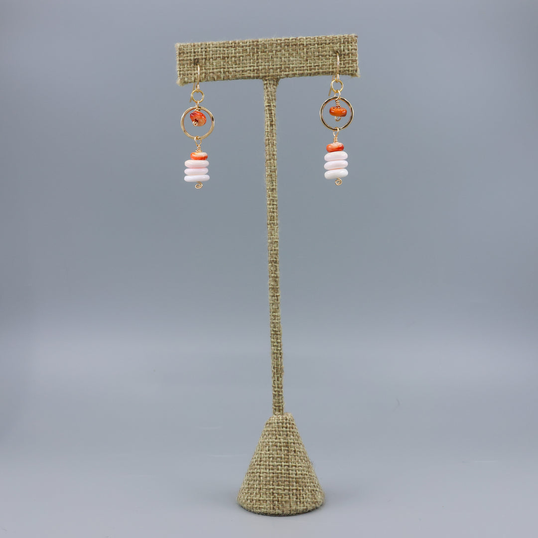 queen conch and spiny oyster gold fill earrings on a linen display hanger