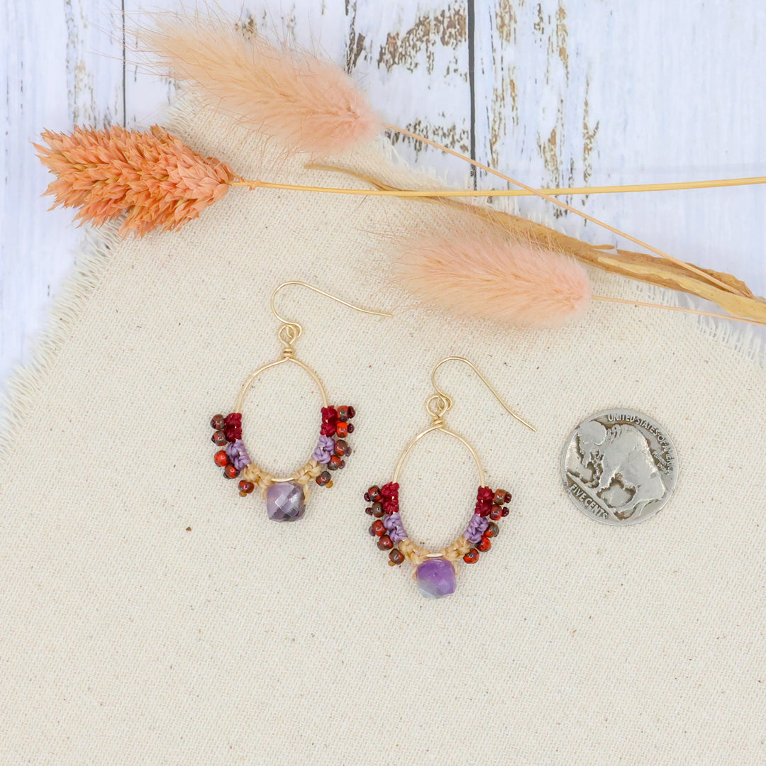 handmade 14k gold filled hoops with macrame and an amethyst bead shown with a coin for size comparison