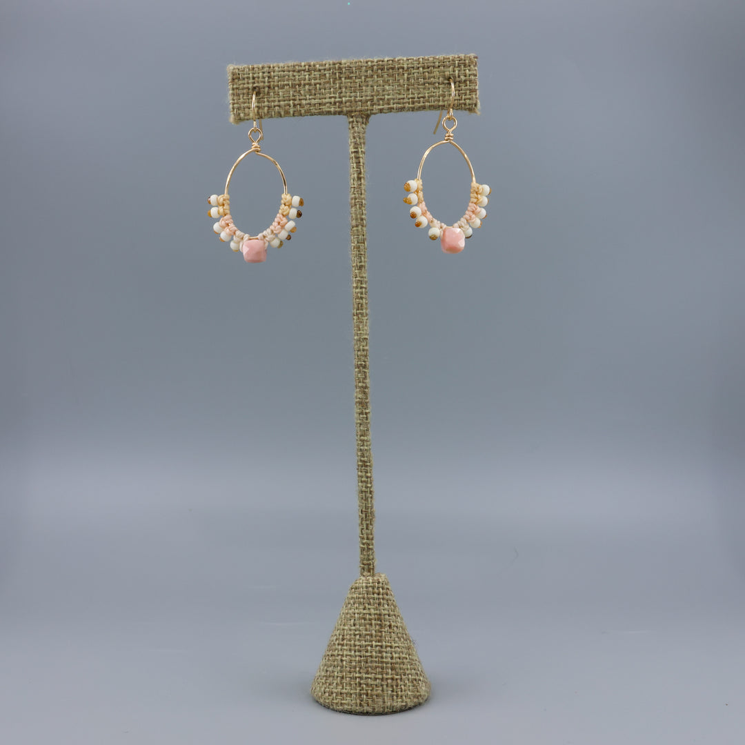handmade gold macrame hoop earrings with a cube shaped pink opal bead