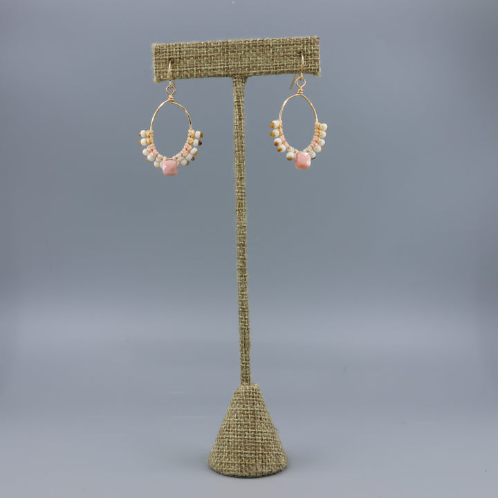 handmade gold macrame hoop earrings with a cube shaped pink opal bead