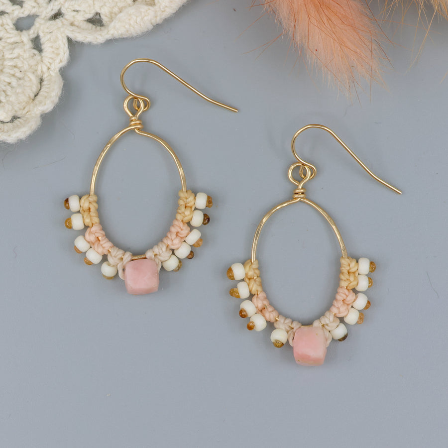 handmade gold macrame hoop earrings with a pink opal bead