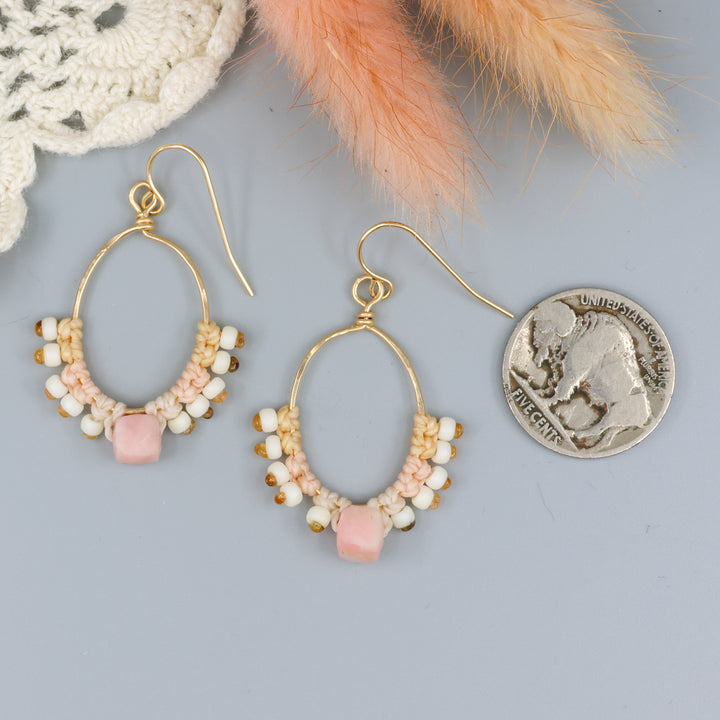 handmade gold macrame hoop earrings with a pink opal bead with a nickel for size comparison