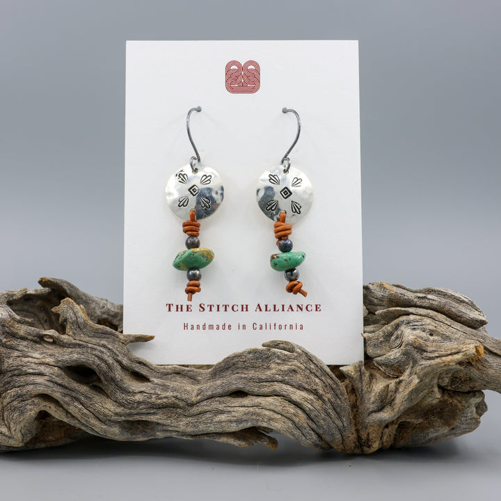 turquoise and stamped sterling silver earrings on white card