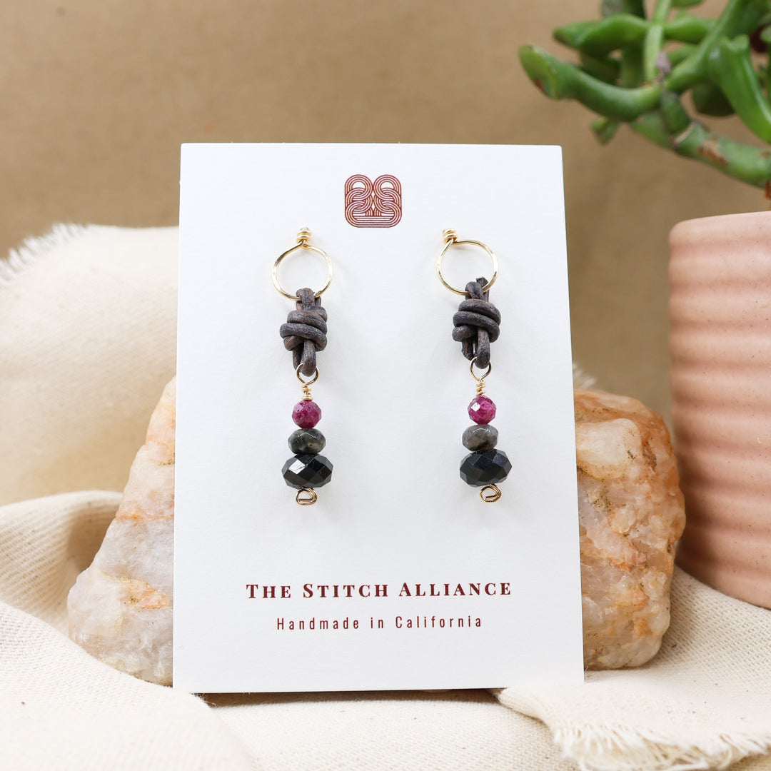 black tourmaline, larvikite, and lapis lazuli 14k gold filled earrings on a white card