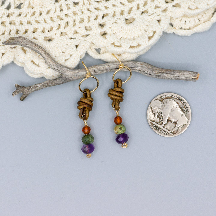 handmade amethyst, green garnet, and hessonite leather and gold fill earrings with a nickel for size comparison
