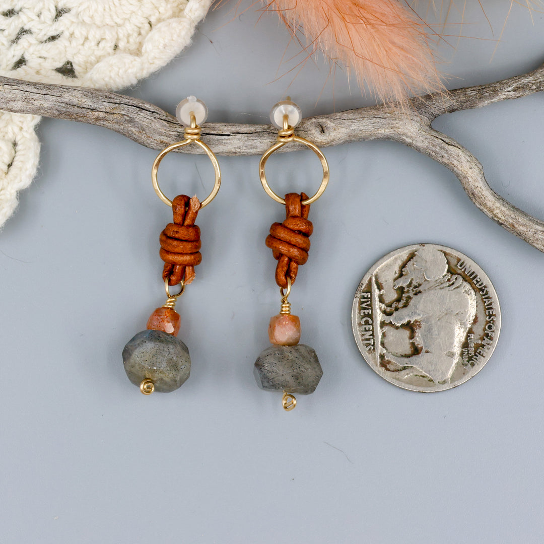 labradorite, sunstone, gold fill, and leather handmade drop earrings with a nickel for size comparison
