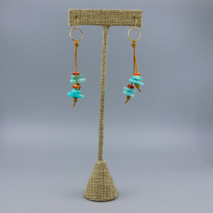 handmade gold fill and leather fringe earrings with amazonite and spiny oyster beads on a linen display hanger