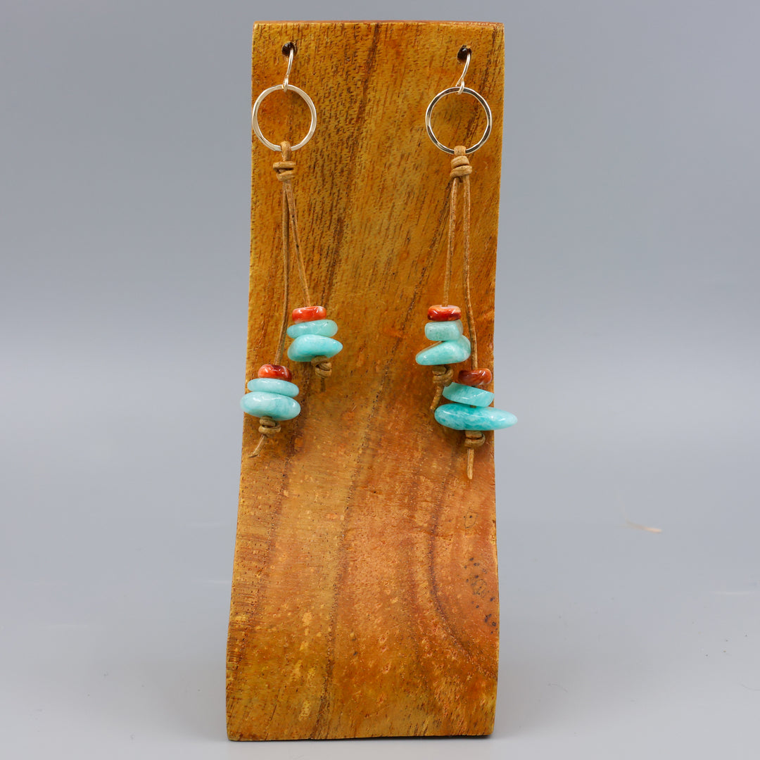 handmade gold fill and leather fringe earrings with amazonite and spiny oyster beads on a wood display