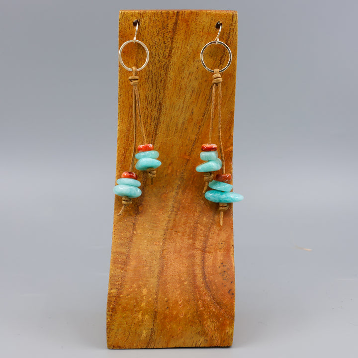 handmade gold fill and leather fringe earrings with amazonite and spiny oyster beads on a wood display