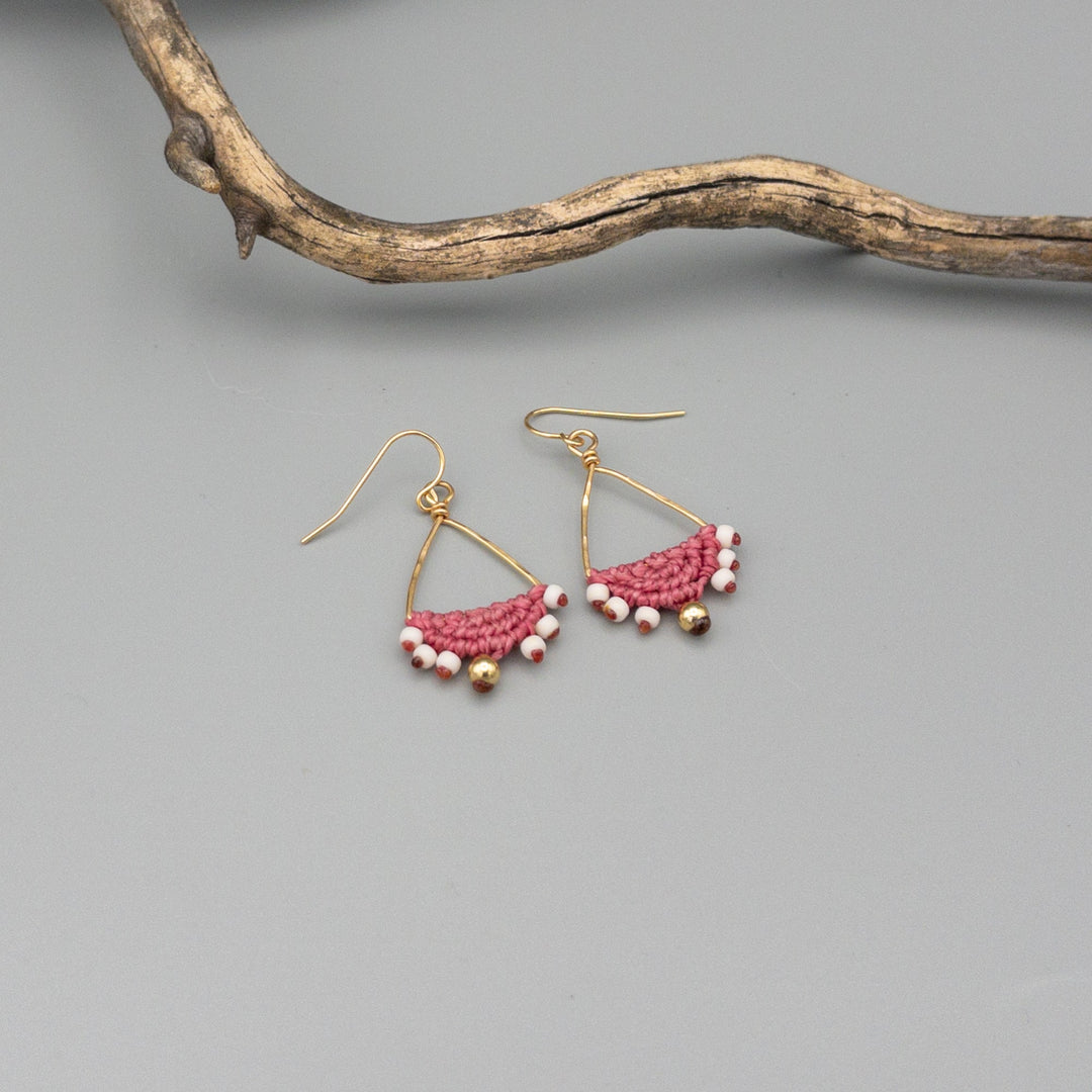 pink macrame triangle hoop earrings in gold fill on gray background