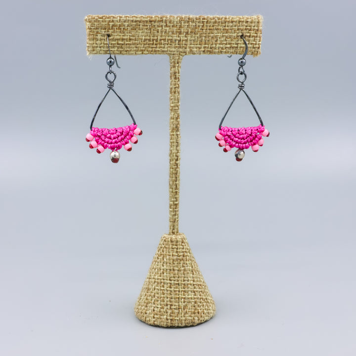 handmade oxidized sterling silver triangle hoop earrings with bright pink macrame on a linen hanger