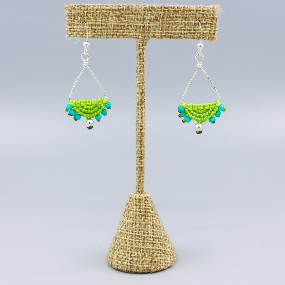 handmade sterling silver triangle hoop earrings with lime green macrame on a linen hanger