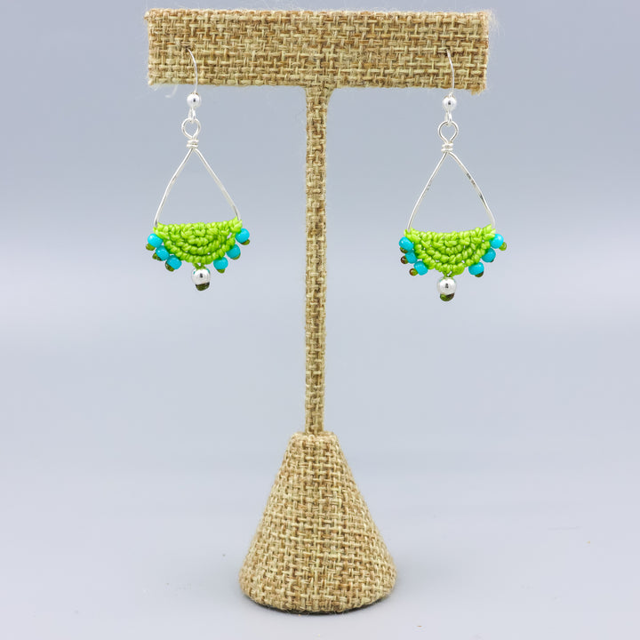handmade sterling silver triangle hoop earrings with lime green macrame on a linen hanger