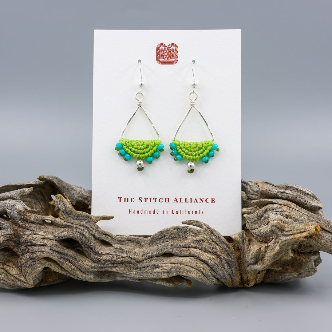 handmade macrame earrings - lime green triangle hoops in sterling silver on a white card