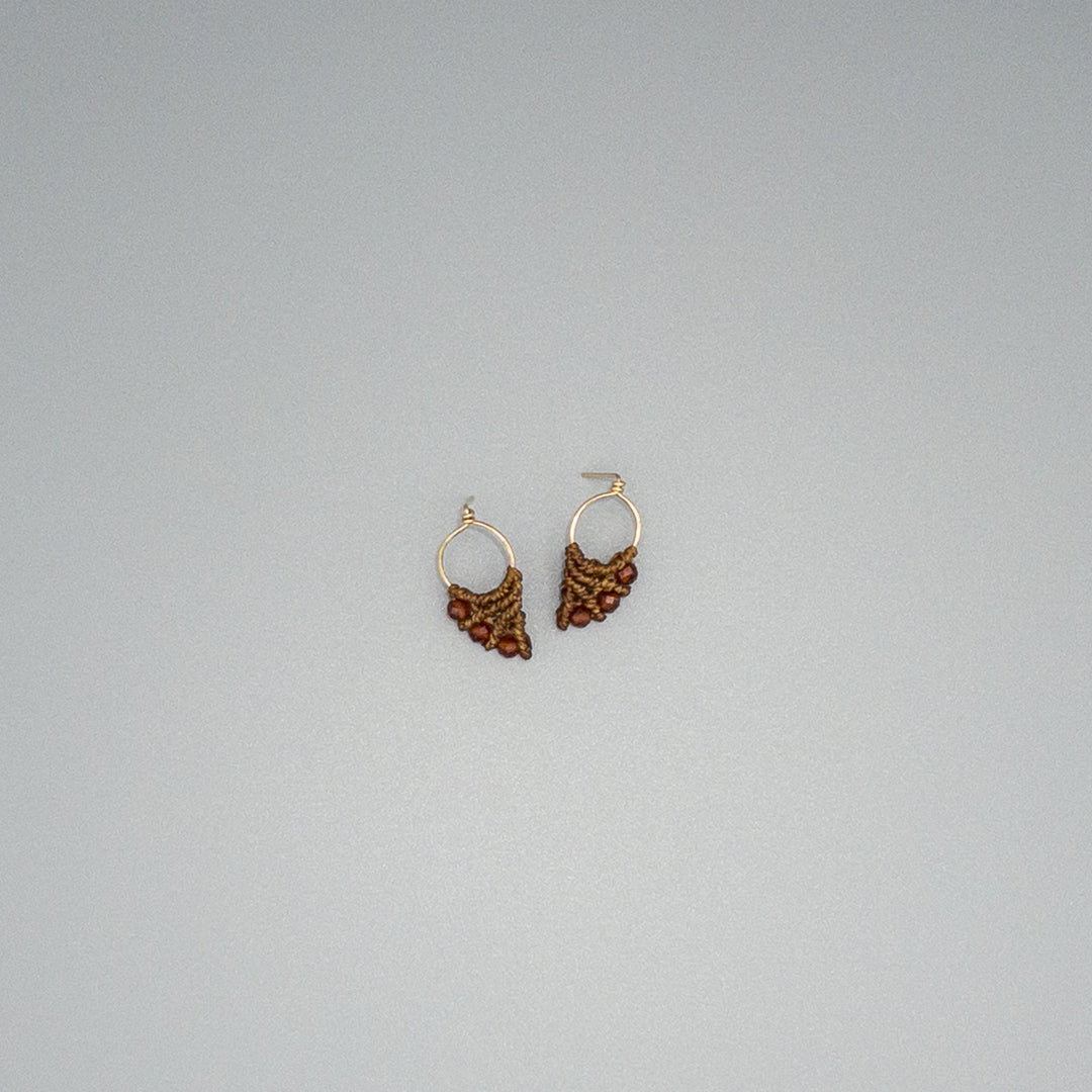 gold fill and hessonite on a gray background