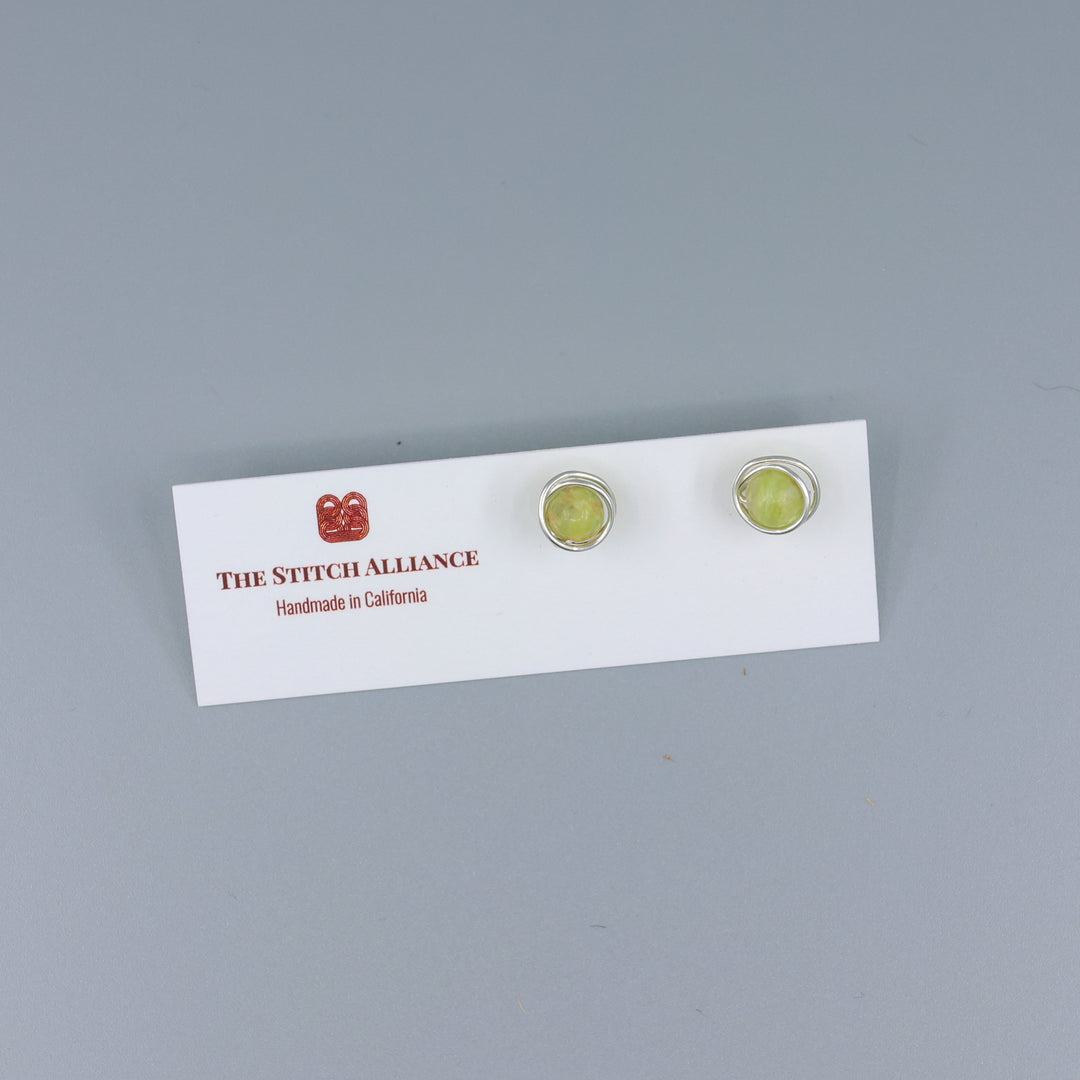 handmade Sterling silver peridot stud earrings on a white card