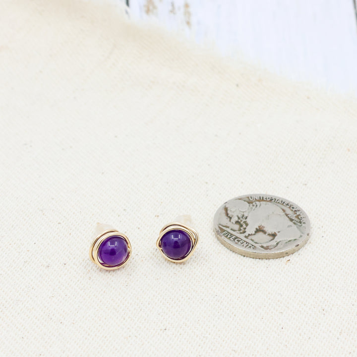 handmade amethyst and gold filled stud earrings with a coin for size comparison