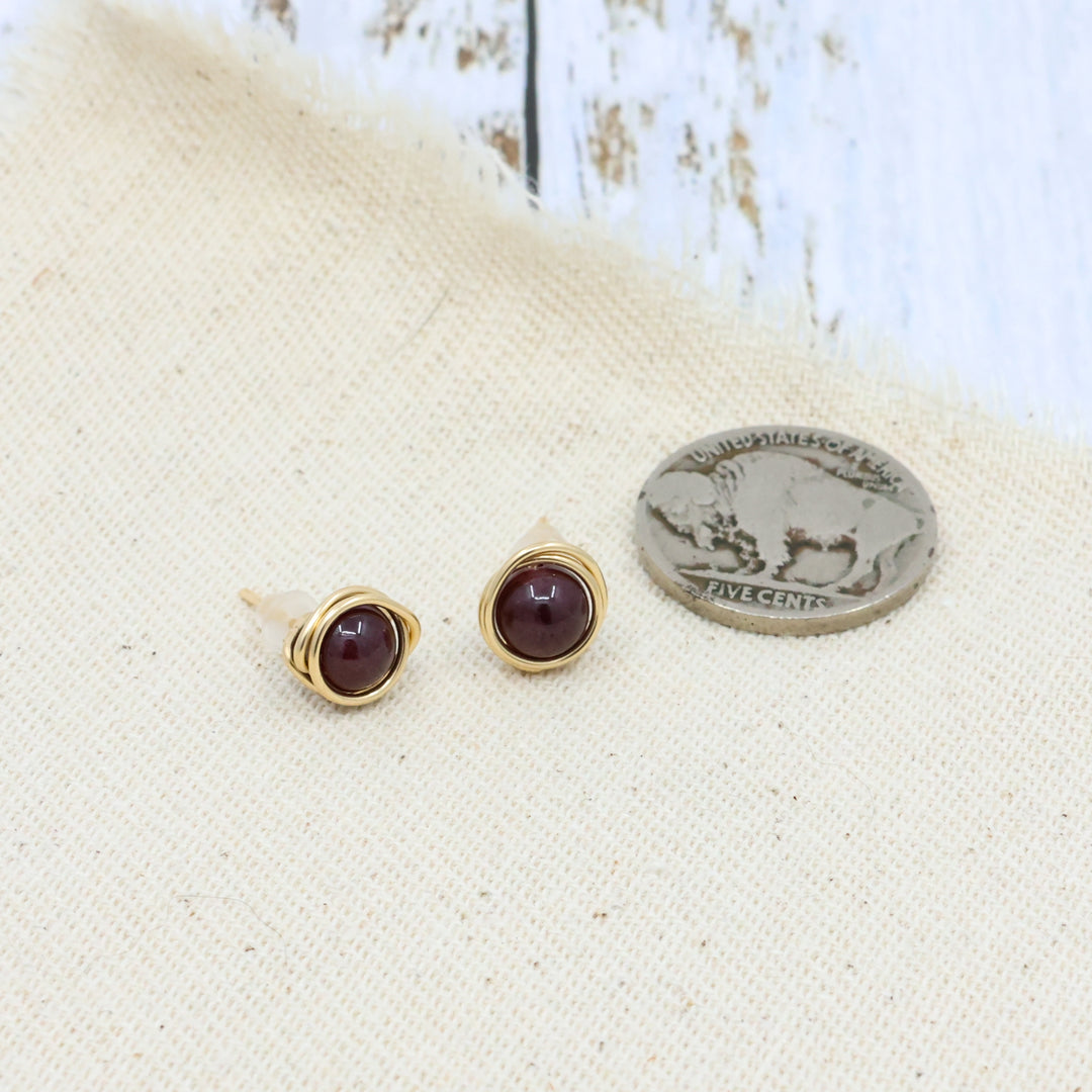 handmade 14k gold fill garnet stud earrings with a coin to show comparison