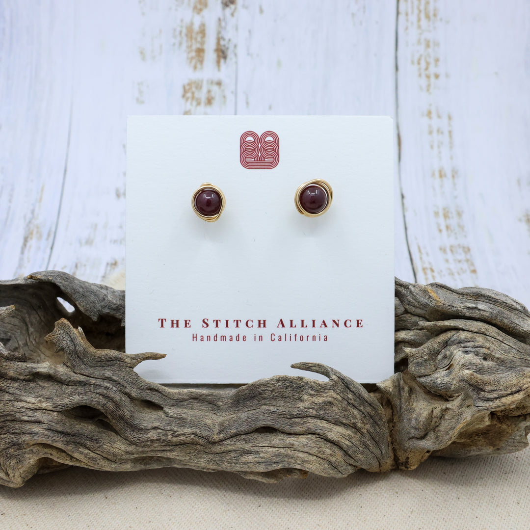handmade 14k gold fill garnet stud earrings on a white card