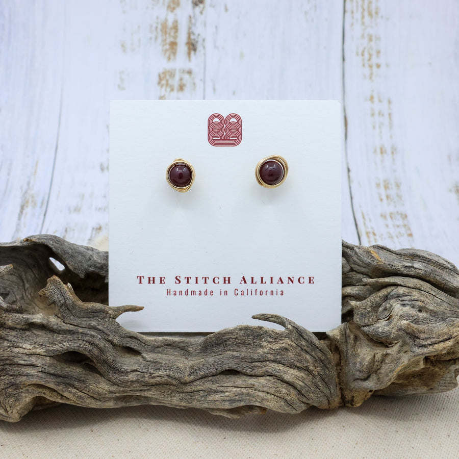 handmade 14k gold fill garnet stud earrings on a white card