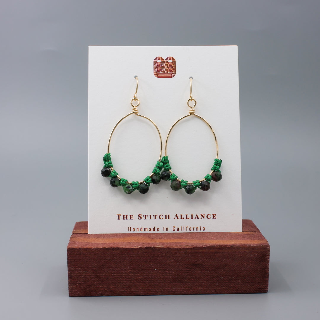 handmade gold hoop macrame earrings with ruby in zoisite beads on a white card