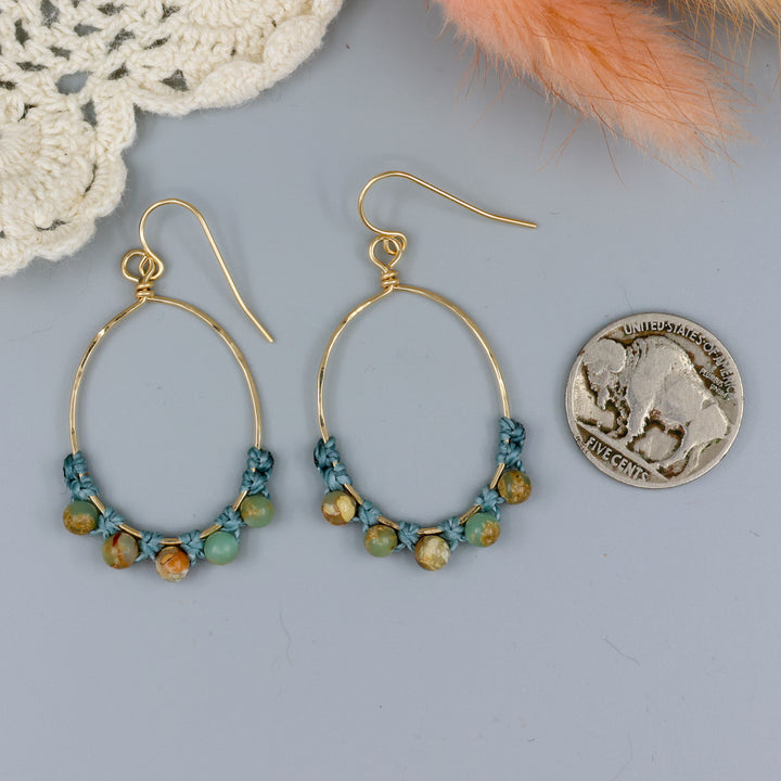 handmade gold hoop macrame earrings with aqua terra jasper beads with a nickel for size comparison