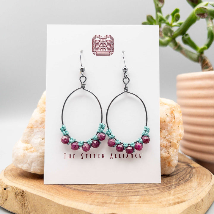 ruby oval hoops oxidized sterling silver on a white background