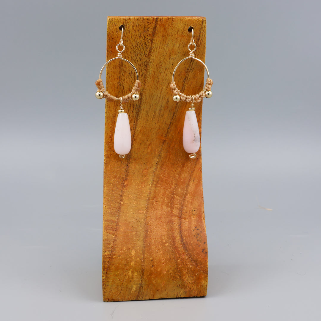 handmade pink opal macrame gold fill hoop earrings on a wood display