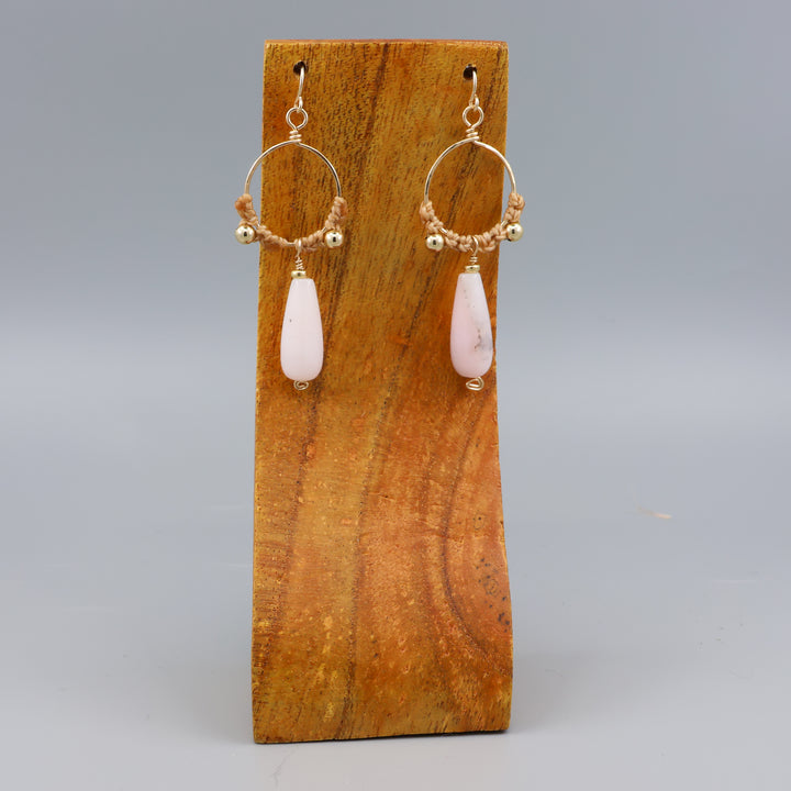handmade pink opal macrame gold fill hoop earrings on a wood display