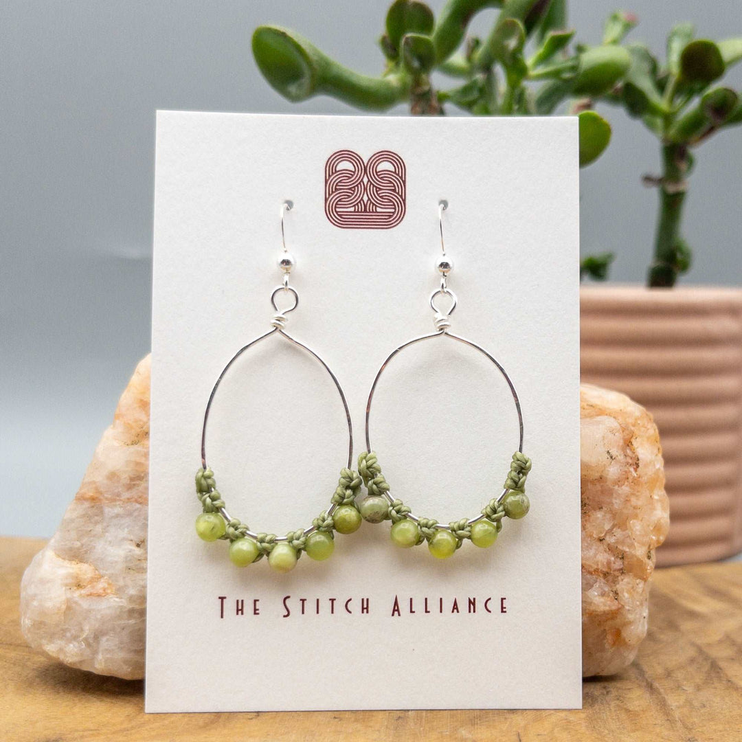 peridot sterling silver hoop earrings on a white card