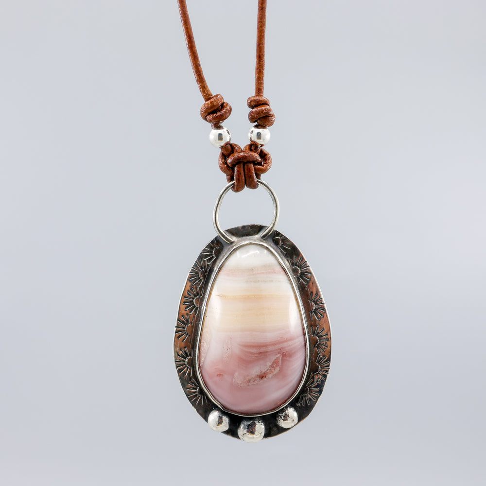 close up of pink and yellow jasper sterling silver necklace on leather cord