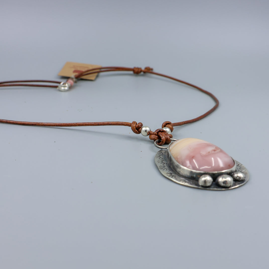 detail view of pink and yellow jasper sterling silver necklace on leather cord
