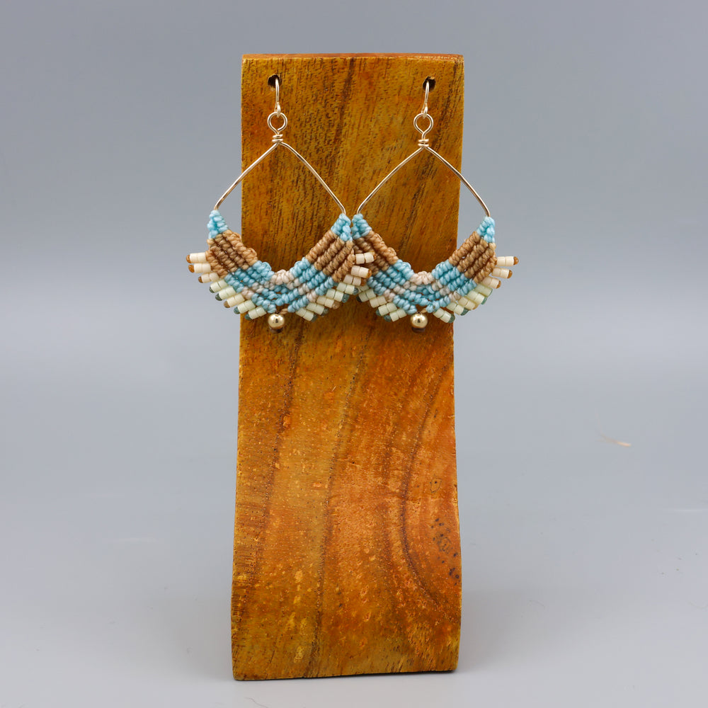 handmade square hoop macrame earrings gold fill and coastal colors on a wood display