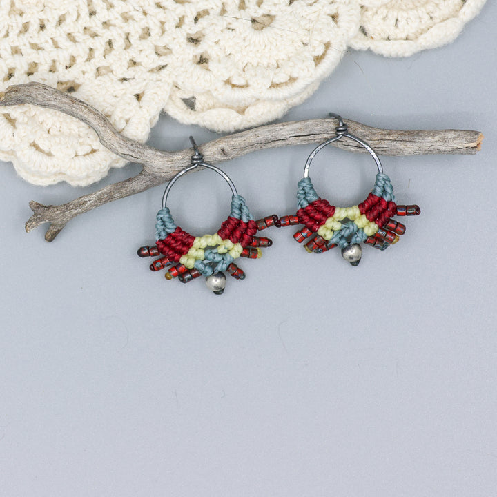 handmade macrame stud earrings in blue, deep red, and pale yellow with oxidized sterling silver metal