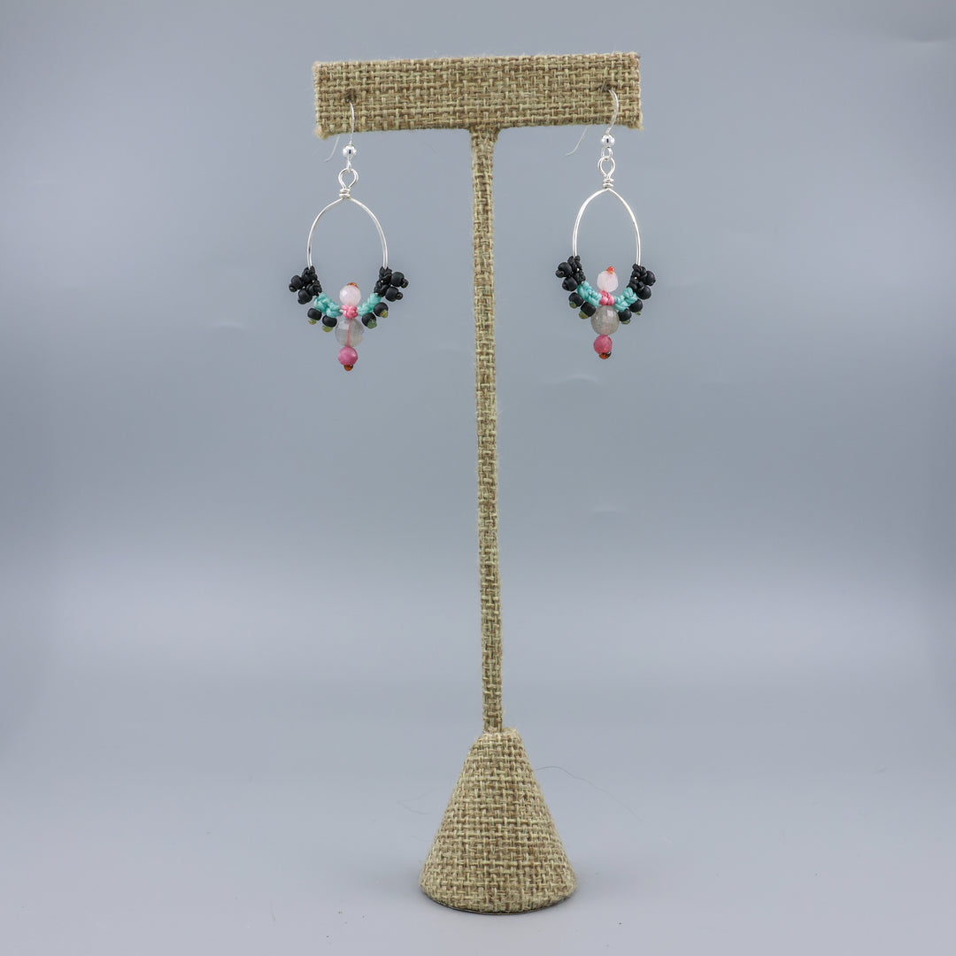 handmade sterling silver macrame hoop earrings with labradorite, tourmaline, and moonstone beads on a linen hanger