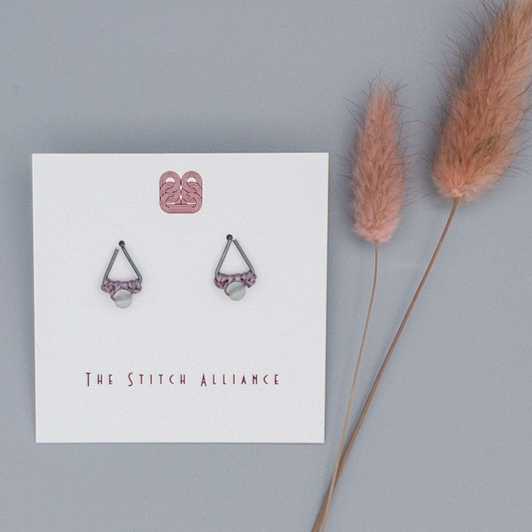 oxidized sterling silver triangle shaped post-style earring with rainbow fluorite bead on a gray background