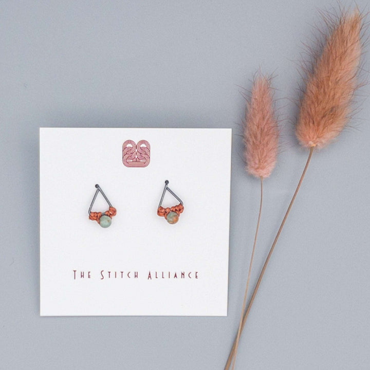 oxidized sterling silver triangle post earrings with small aqua terra jasper beads on a gray background