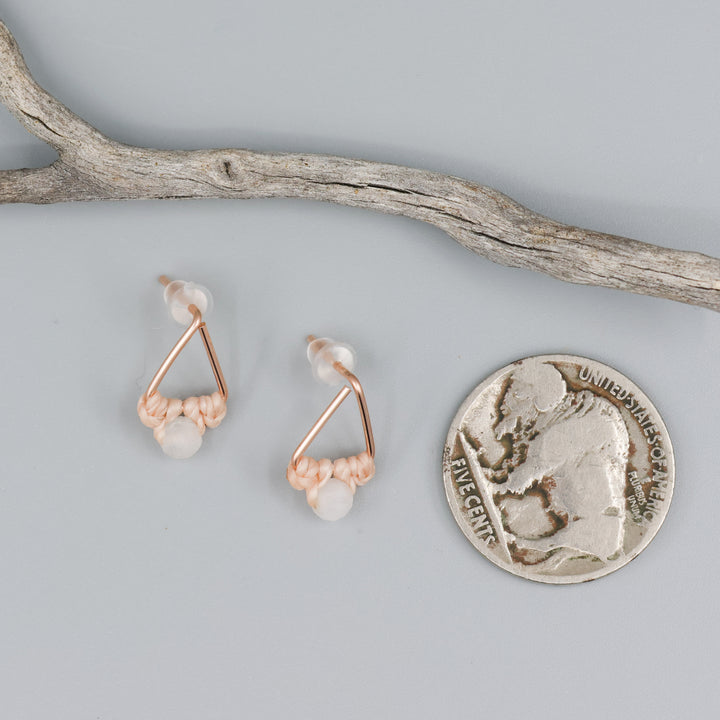 rose gold triangle earrings with moonstone bead with coin for size comparison