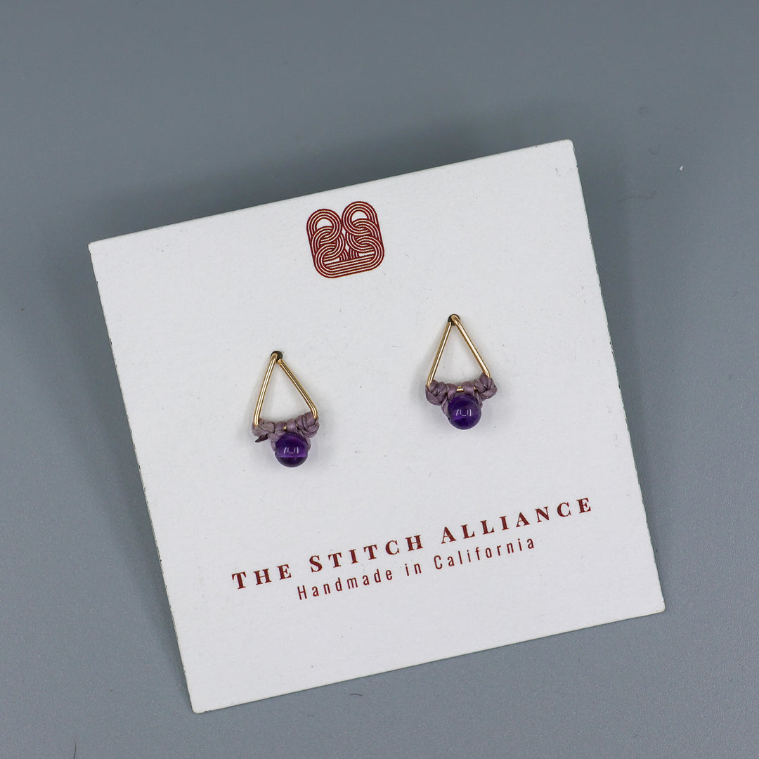 handmade gold fill amethyst triangle stud earrings on a white card with gray background